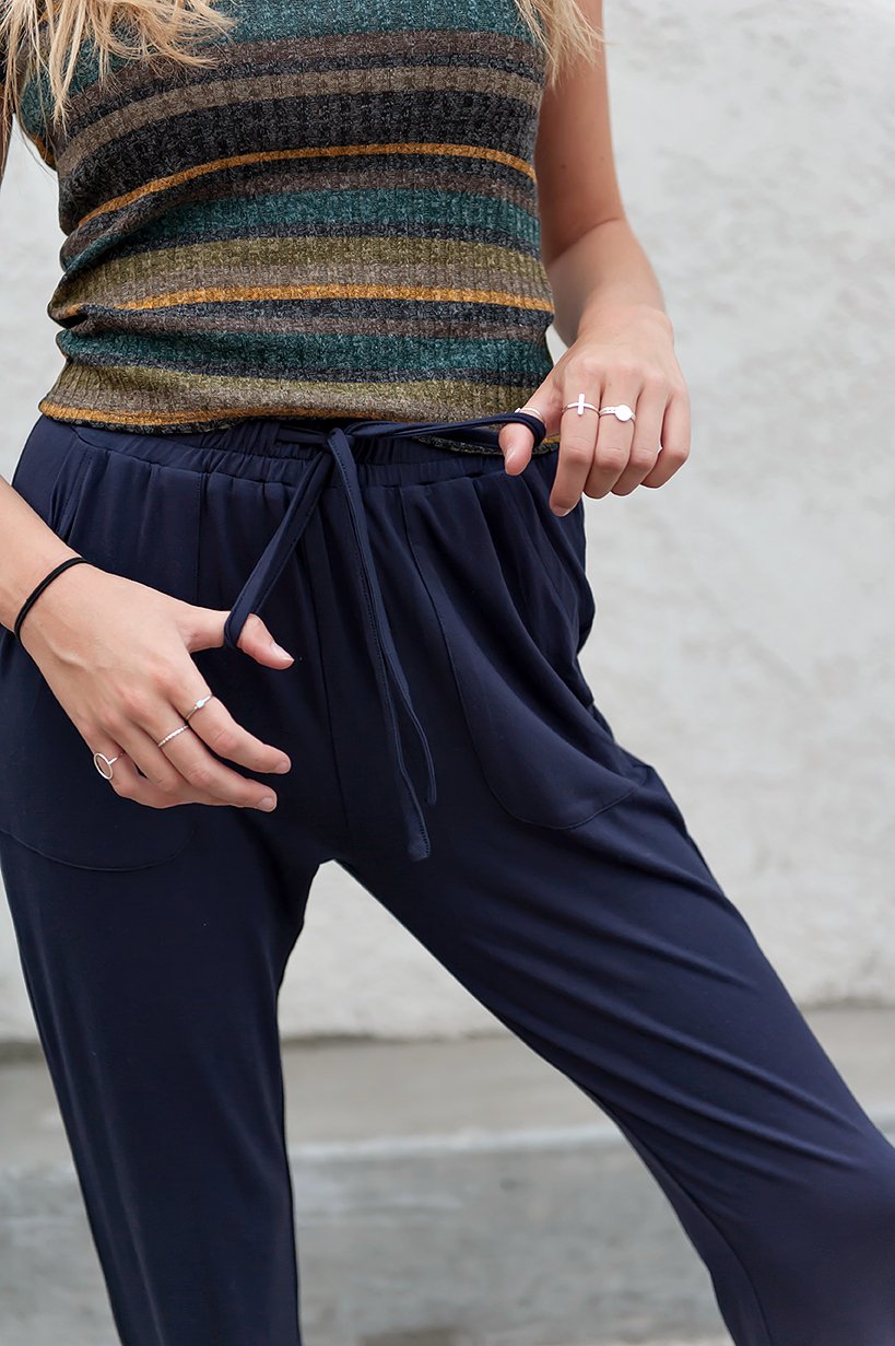 DT Shelby Tie-ankle pants in Navy featuring a feminine knot at the ankle, adjustable drawstring waistband, and functional pockets.