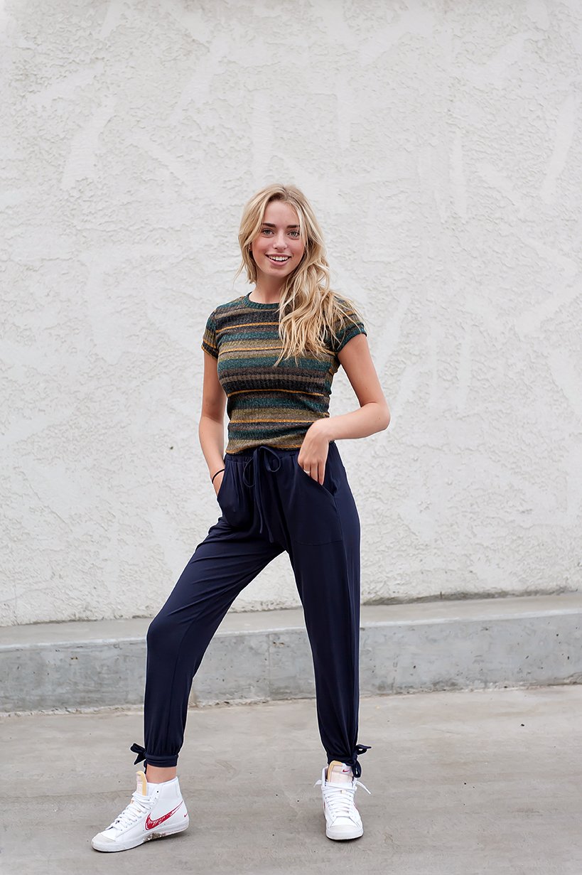 DT Shelby Tie-ankle pants in Navy featuring a feminine knot at the ankle, adjustable drawstring waistband, and functional pockets.