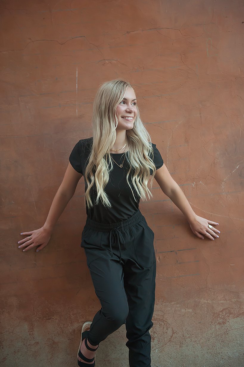 DT UNITY Jumpsuit in Black featuring cap sleeves, side pockets, and an adjustable tie waist, perfect for women and teens.