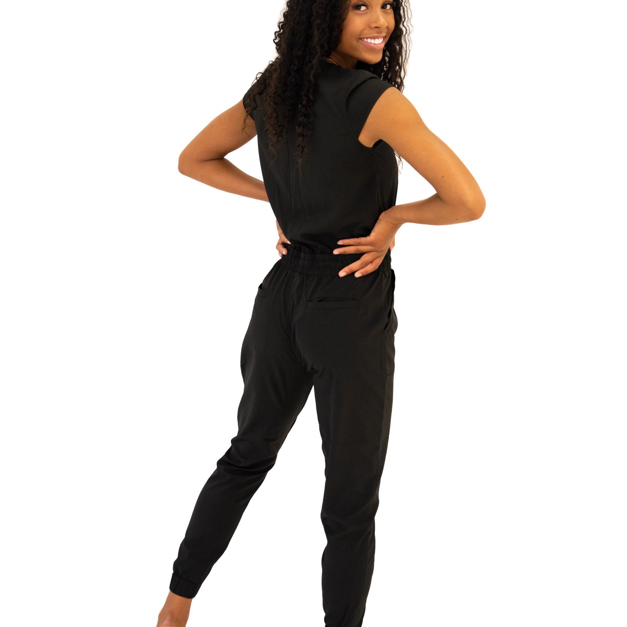 DT UNITY Jumpsuit in Black featuring cap sleeves, side pockets, and an adjustable tie waist, perfect for women and teens.