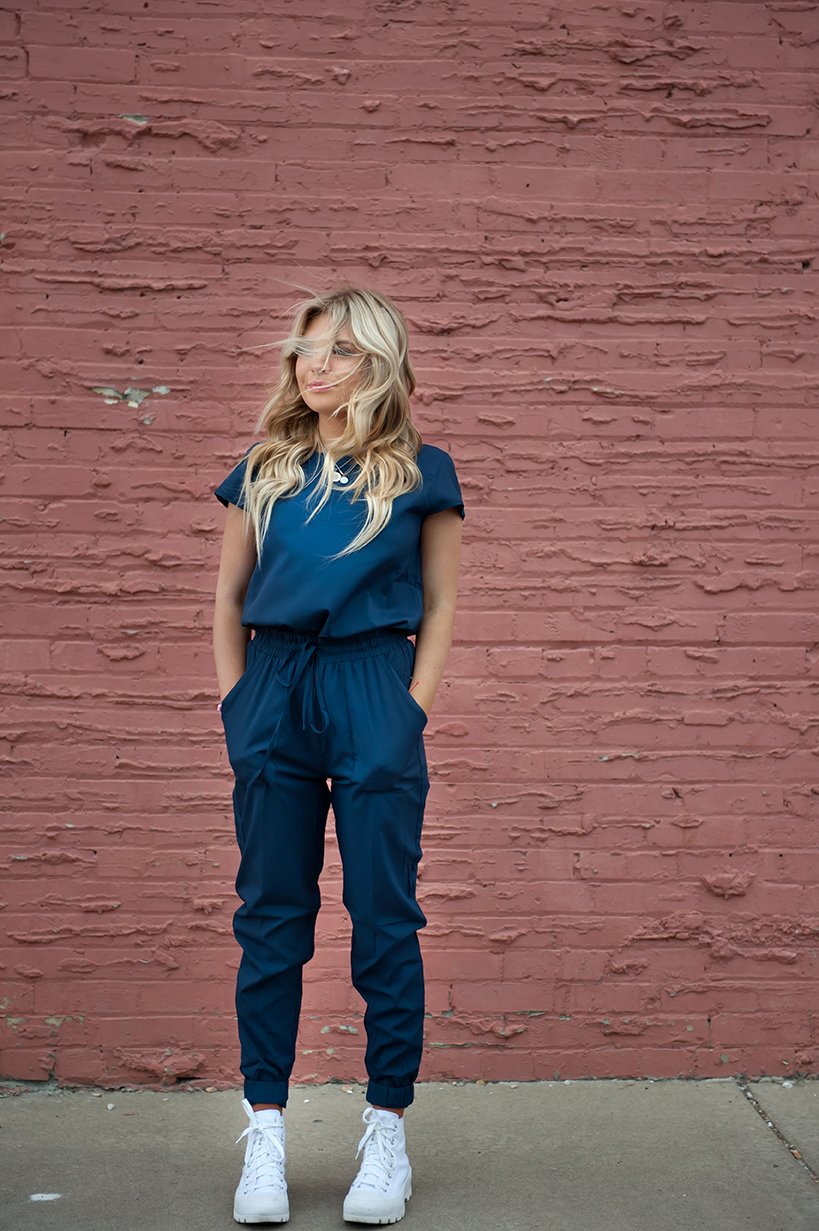 DT Unity Jumpsuit in Navy featuring cap sleeves, elastic waist, and slim cut legs, perfect for women and teens.