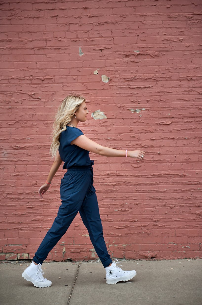 DT Unity Jumpsuit in Navy featuring cap sleeves, elastic waist, and slim cut legs, perfect for women and teens.