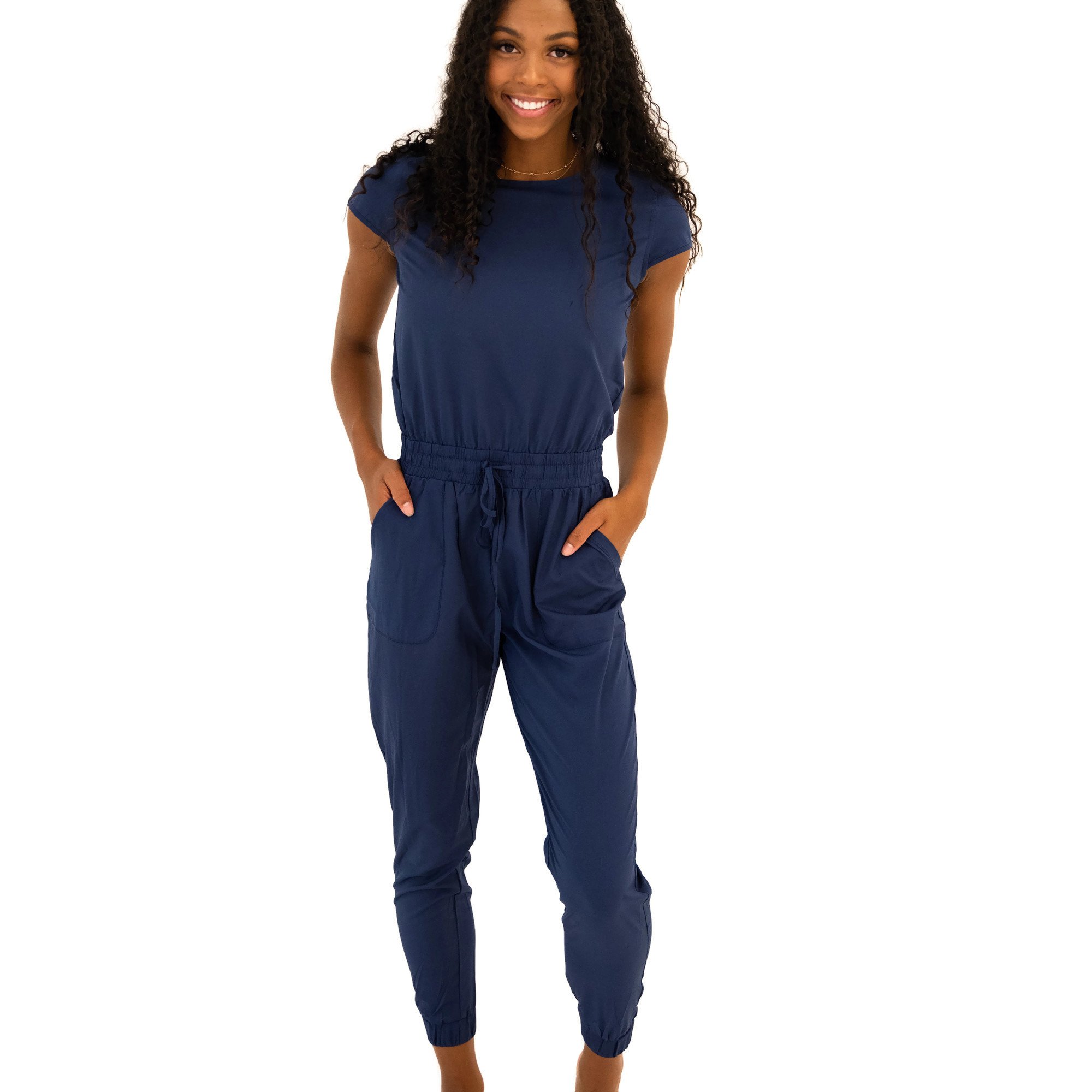 DT Unity Jumpsuit in Navy featuring cap sleeves, elastic waist, and slim cut legs, perfect for women and teens.