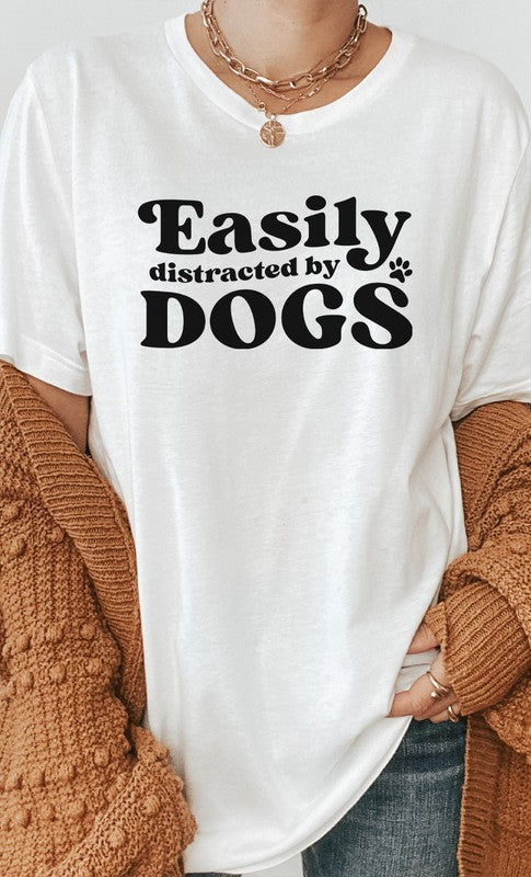 Easily Distracted By Dogs Graphic Tee featuring a paw print design, available in various colors.