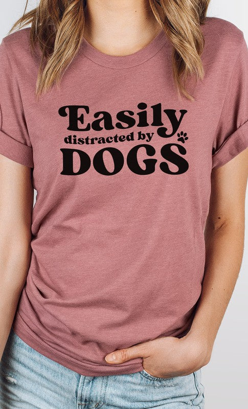 Easily Distracted By Dogs PLUS Graphic Tee featuring a cute paw print design in various colors, made from soft cotton/poly blend fabric.