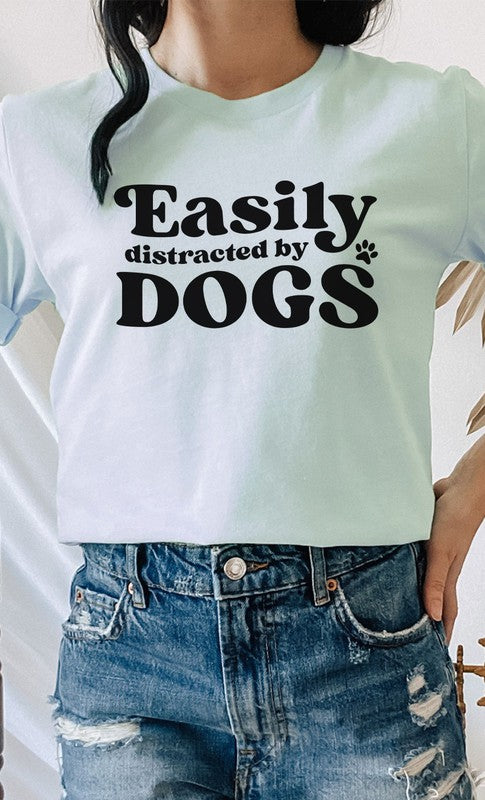 Easily Distracted By Dogs PLUS Graphic Tee featuring a cute paw print design in various colors, made from soft cotton/poly blend fabric.