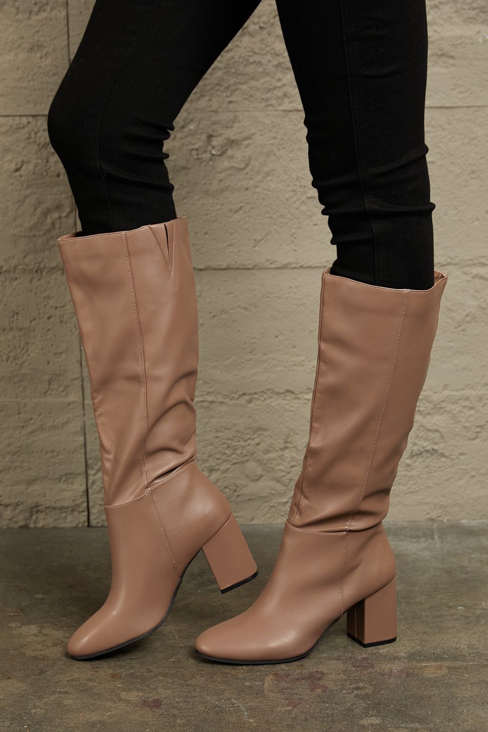 East Lion Corp Block Heel Knee High Boots in luxurious faux leather, featuring a stylish knee-high design and sturdy block heel.