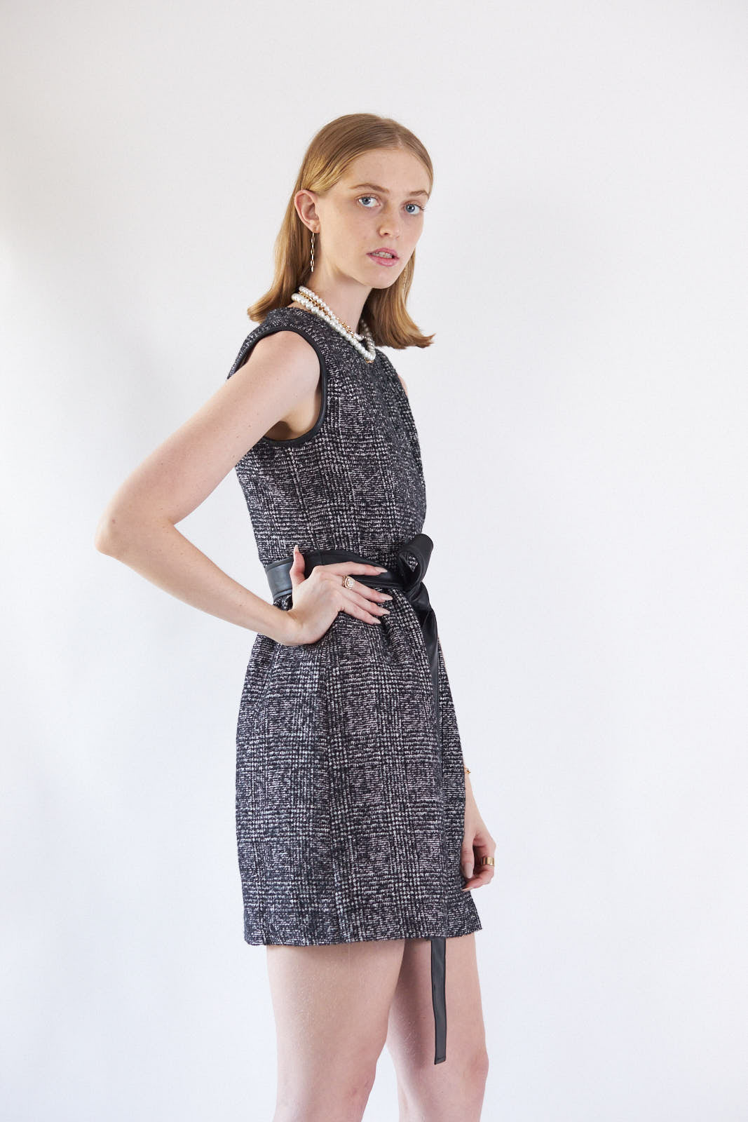 Ebony Mini Tweed Dress displayed on a mannequin, showcasing its elegant design and premium fabric.