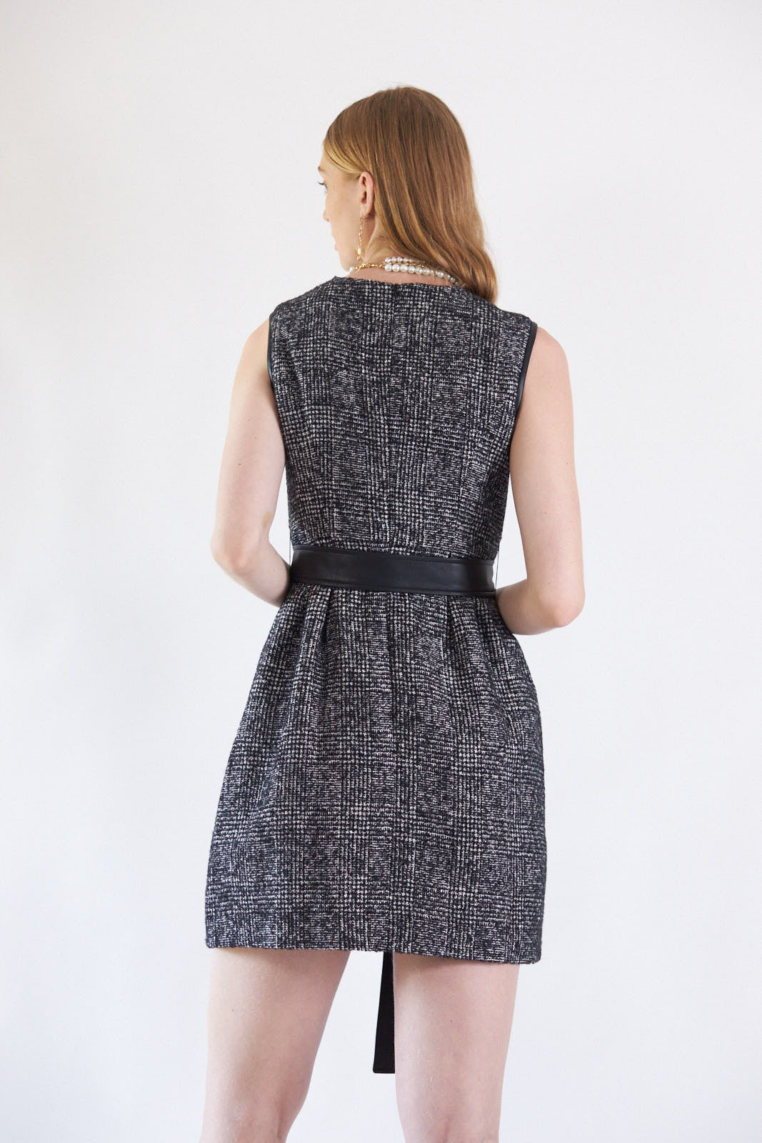 Ebony Mini Tweed Dress displayed on a mannequin, showcasing its elegant design and premium fabric.