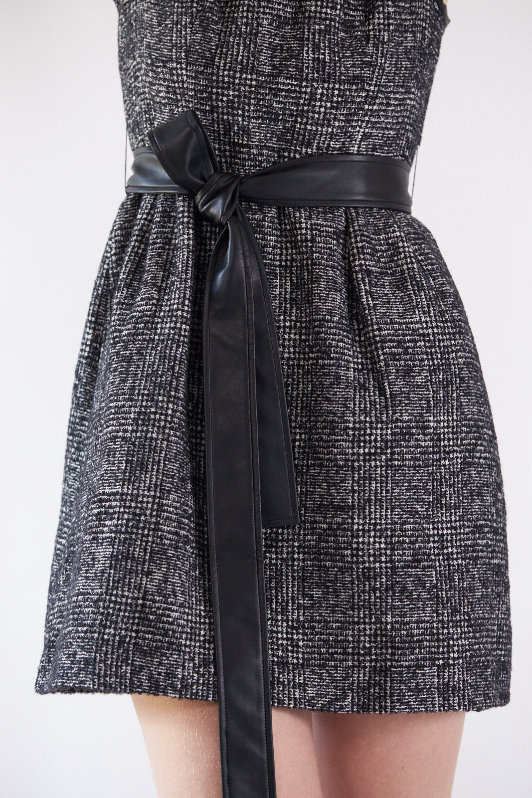 Ebony Mini Tweed Dress displayed on a mannequin, showcasing its elegant design and premium fabric.