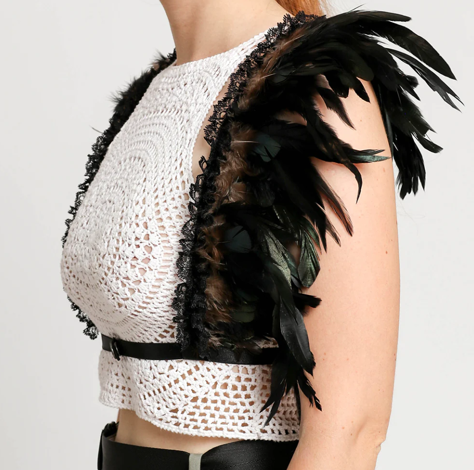 Black elastic strap bra with decorative feathers and lace, featuring adjustable straps and front closure.