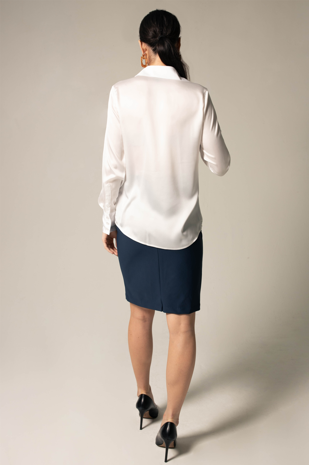 Elegance Silk Blouse in White, showcasing its luxurious silk charmeuse fabric and button-up design.