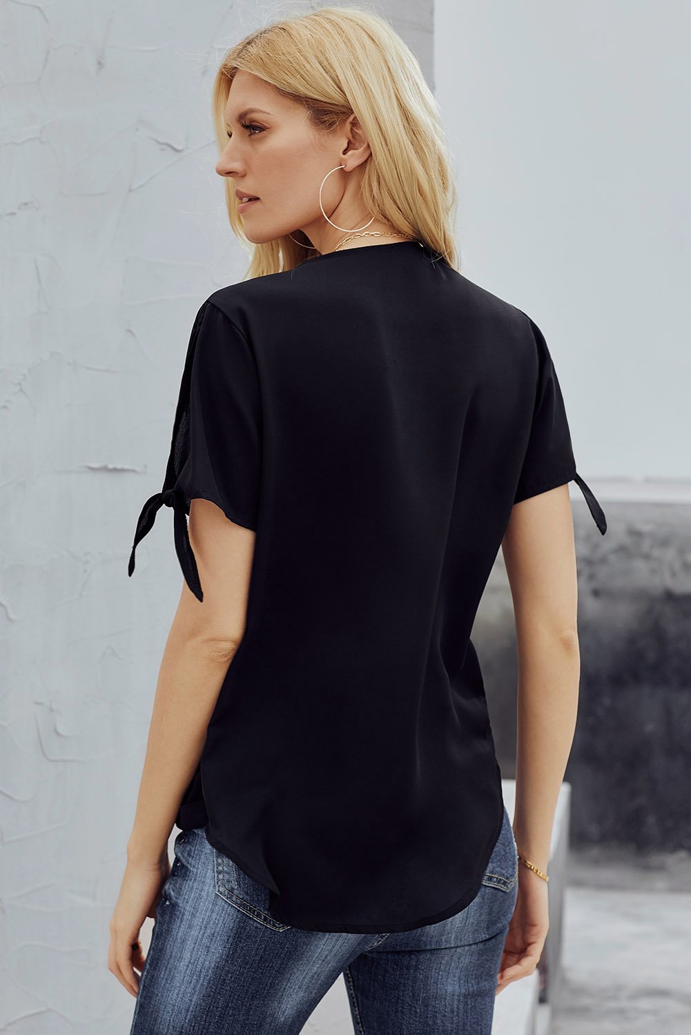 Elegant Black Charismatic Drape Short Sleeve Blouse featuring a v-neckline, tie sleeves, and a stylish drape silhouette.