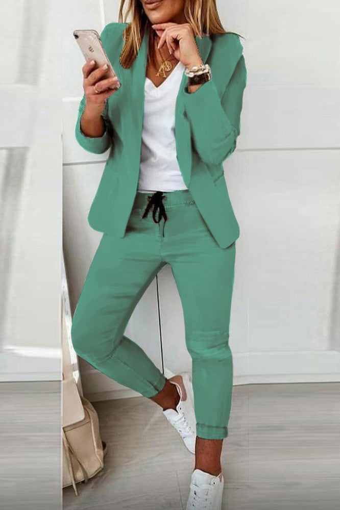 Elegant mint blazer and pants set, featuring a classic collar, long sleeves, and fitted trousers with a drawstring waist.