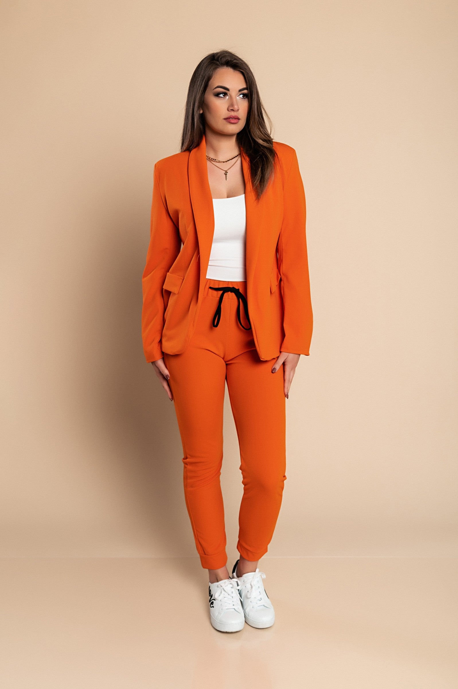 Elegant orange blazer and pants set Estrena, showcasing a classic collar, long sleeves, and fitted trousers with a drawstring waist.