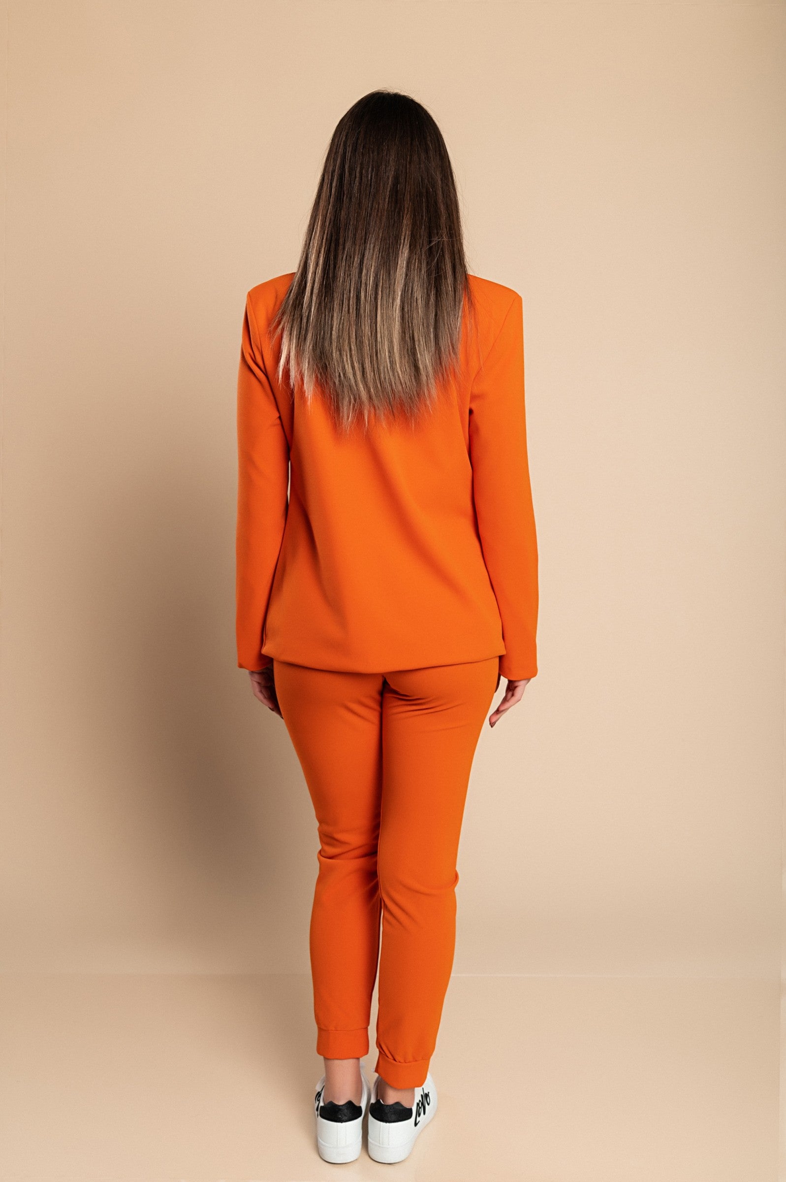 Elegant orange blazer and pants set Estrena, featuring a classic collar, long sleeves, and fitted trousers with an elastic drawstring waist.