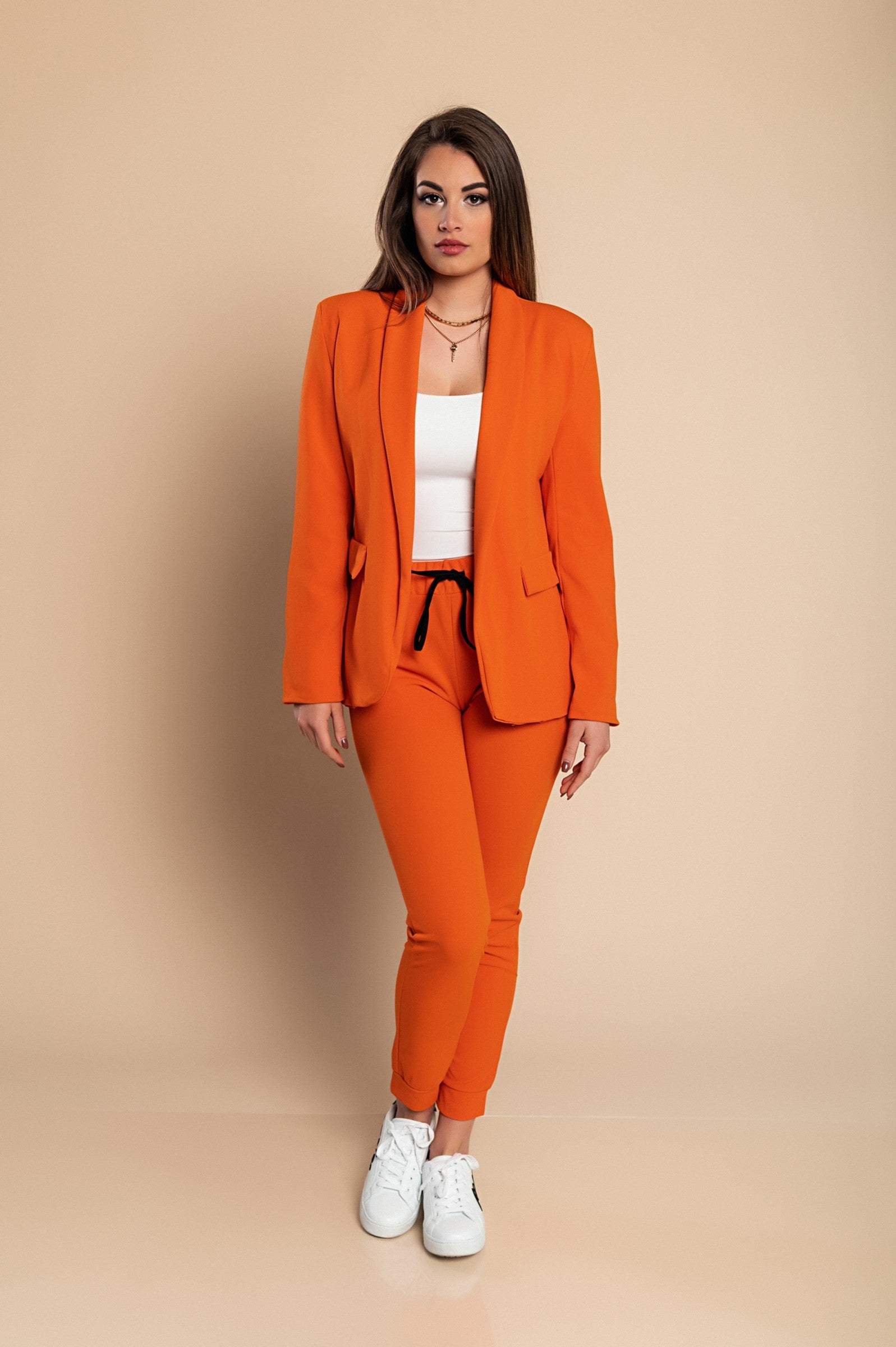 Elegant orange blazer and pants set Estrena, featuring a classic collar, long sleeves, and fitted trousers with an elastic drawstring waist.