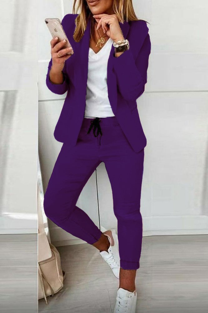 Elegant purple blazer and pants set Estrena, featuring long sleeves, classic collar, and fitted trousers with drawstring waist.