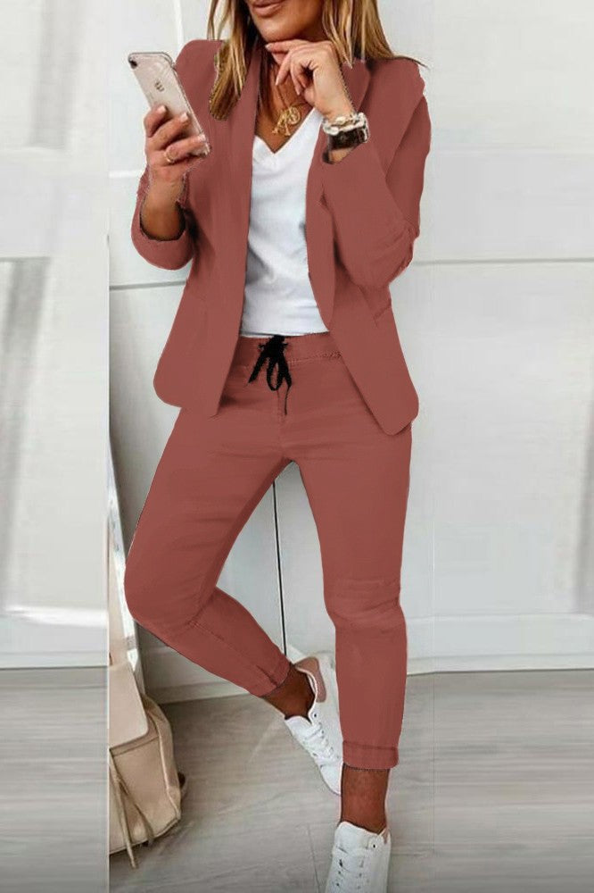 Elegant salmon blazer and pants set, featuring a classic collar, long sleeves, and fitted trousers with an elastic drawstring waist.