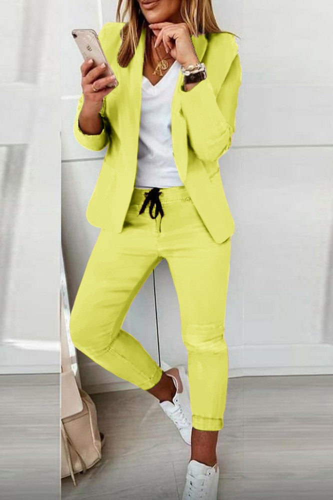 Elegant yellow blazer and pants set, featuring a classic collar, long sleeves, and fitted trousers with a drawstring waist.