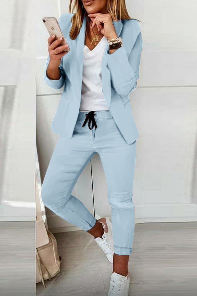 Elegant light blue blazer pants set with long sleeves and drawstring waist, showcasing modern design and Italian craftsmanship.