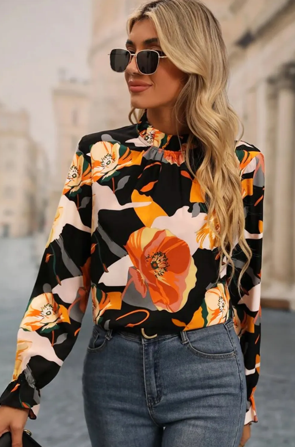 Elegant black high neck blouse with floral print and long sleeves, featuring a loose fit and cuffed wrists.