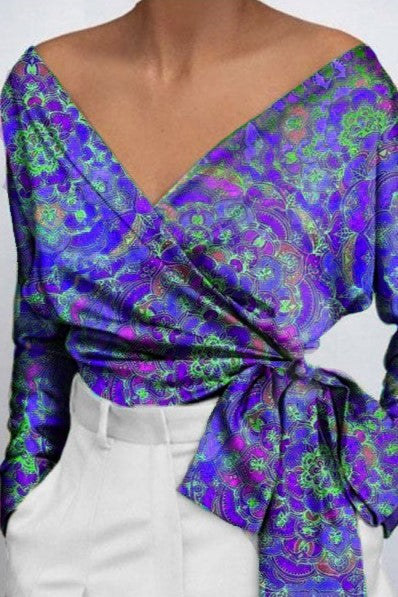 Elegant purple blouse with print, featuring a deep V neckline and bow ribbons on the side, made of high-quality faux satin.