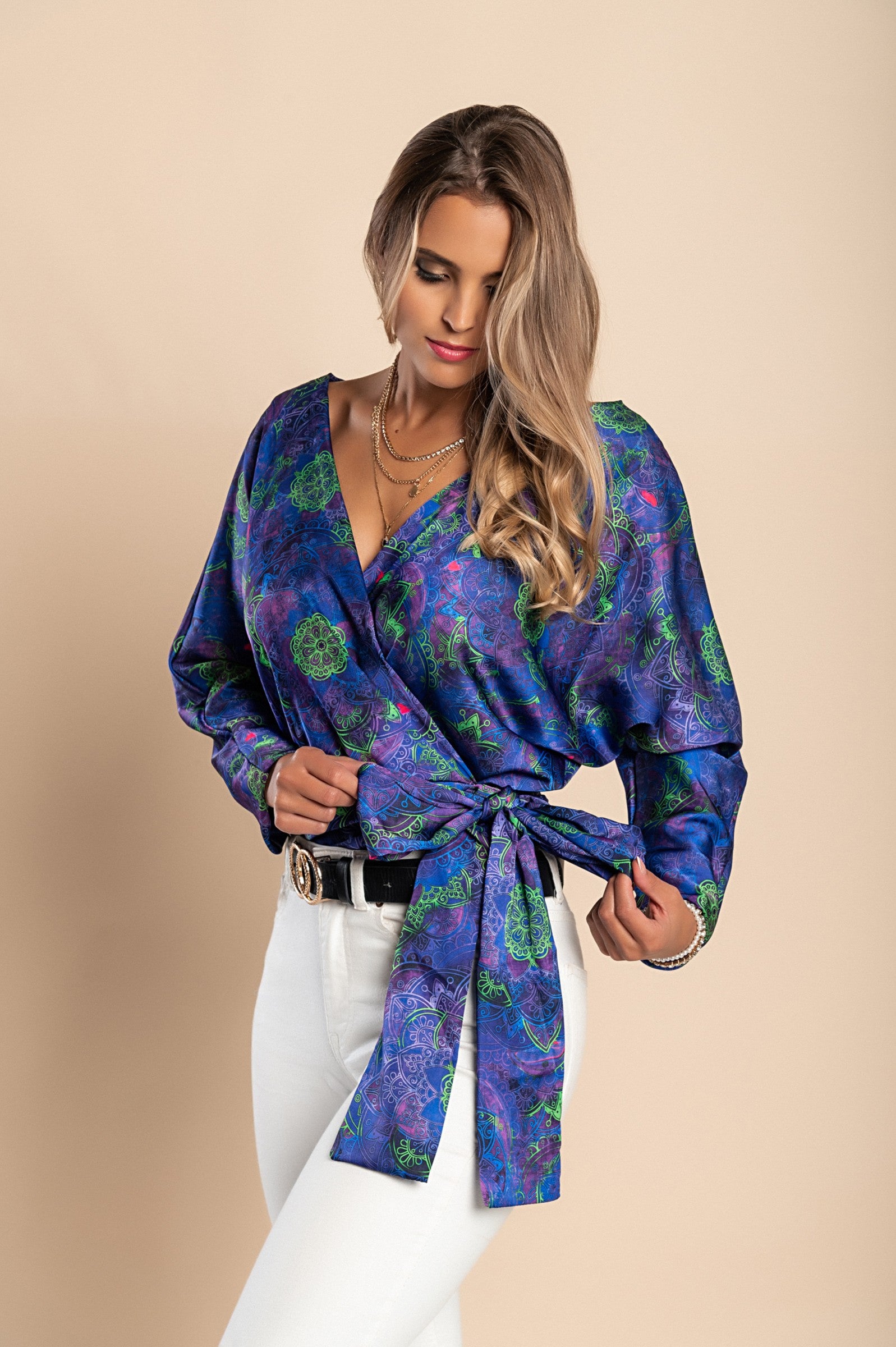 Elegant purple blouse with print, featuring a deep V neckline and bow ribbons on the side, made of high-quality faux satin.