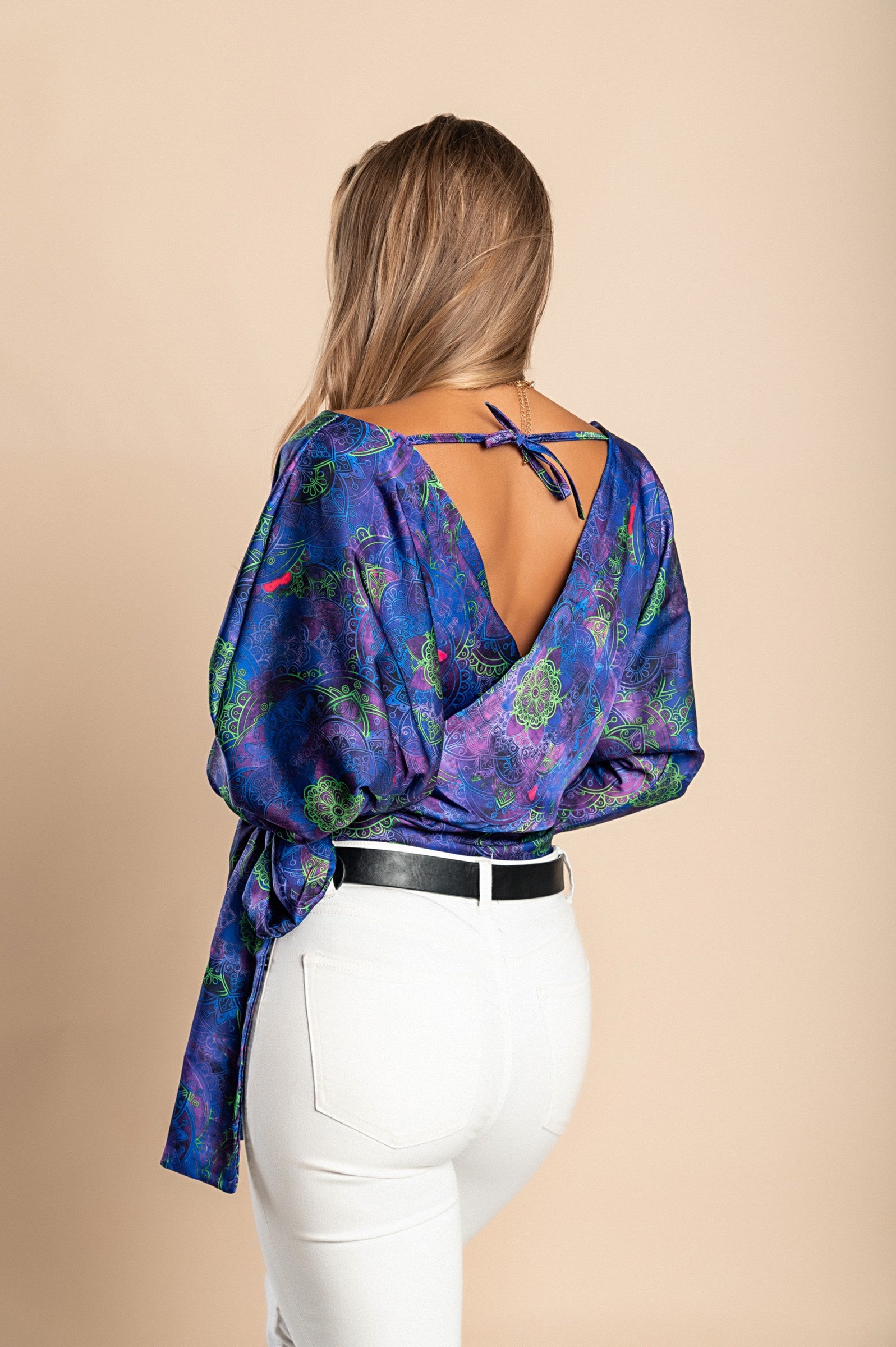 Elegant purple blouse with print, featuring a deep V neckline and bow ribbons on the side, made of high-quality faux satin.