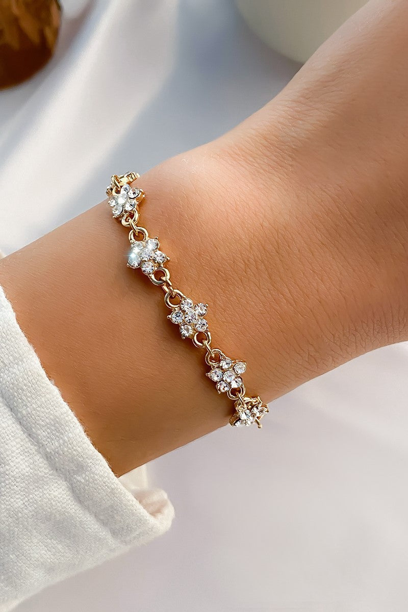 Elegant gold bracelet adorned with sparkling rhinestones and a secure metal lobster clasp.