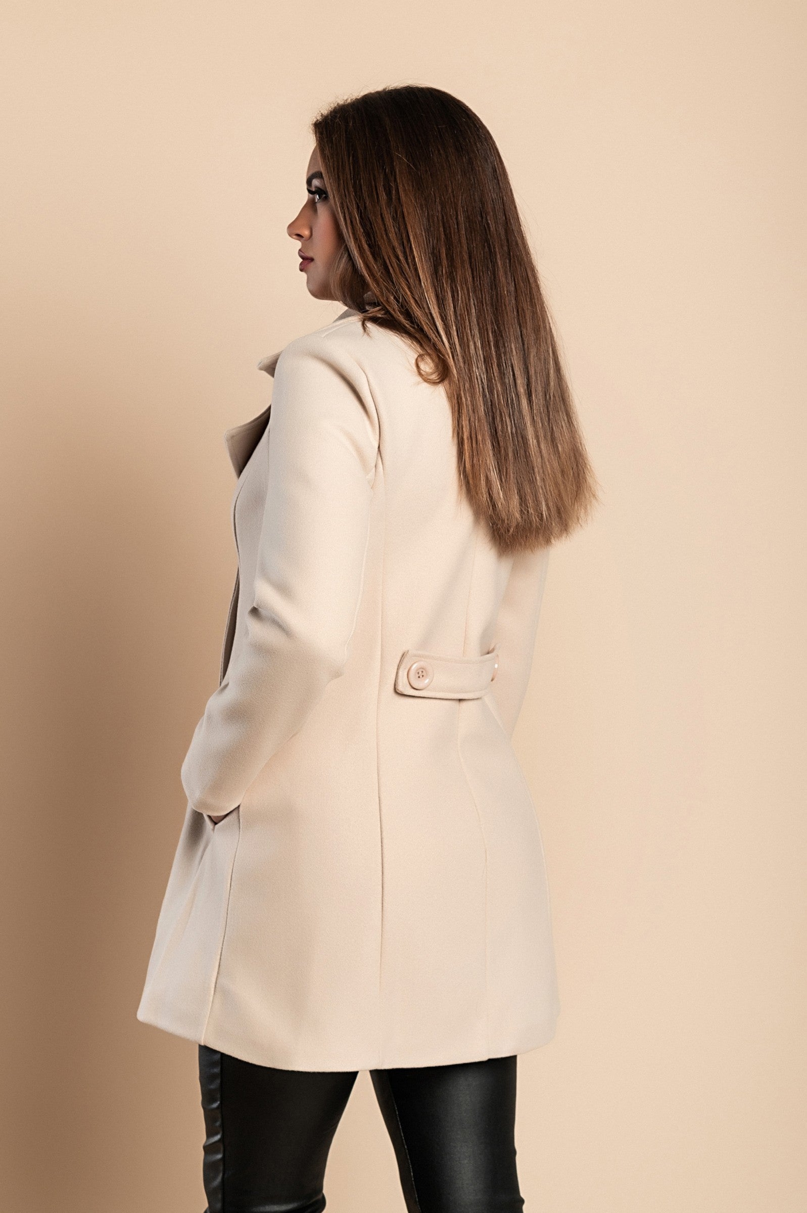 Elegant beige coat with buttons, featuring a classic collar and side pockets, made from high-quality polyester fabric.