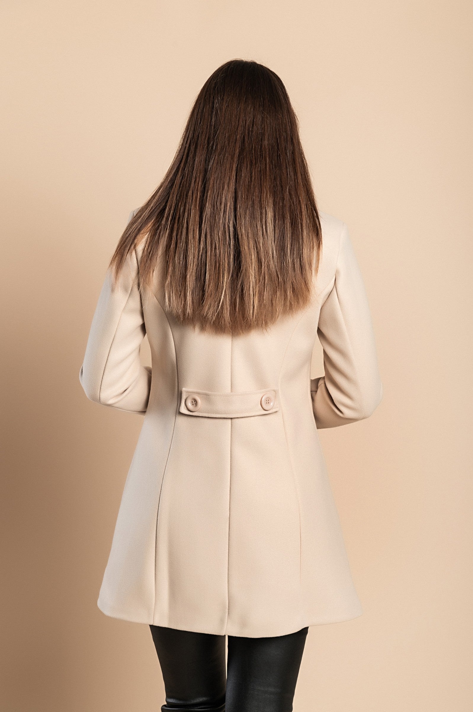 Elegant beige coat with buttons, featuring a classic collar and side pockets, made from high-quality polyester fabric.