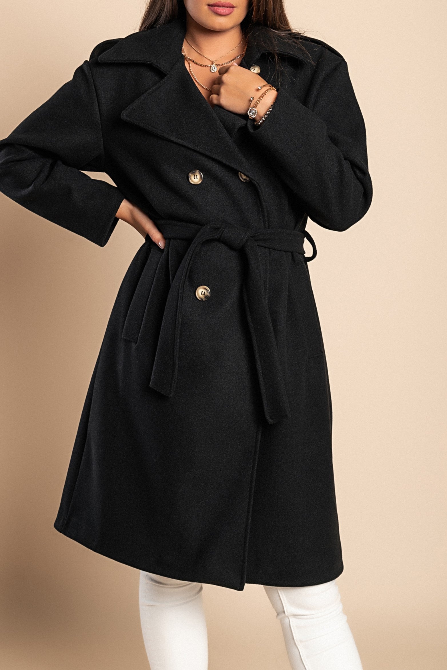 Elegant black coat with buttons, featuring a classic collar and decorative belt, knee-length design, and side pockets.