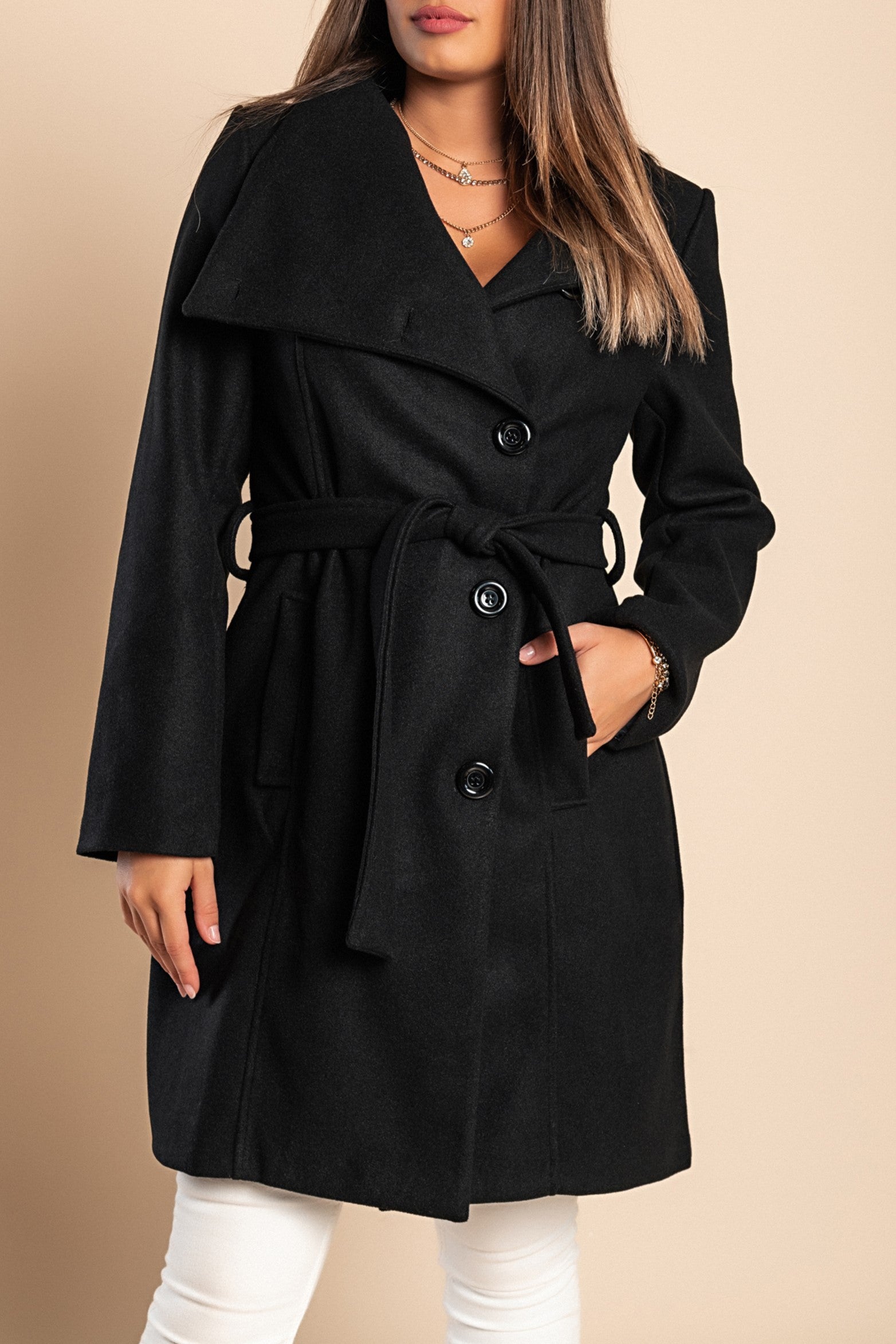 Elegant black coat with buttons, featuring a high collar, long sleeves, and a decorative belt, made from soft polyester fabric.