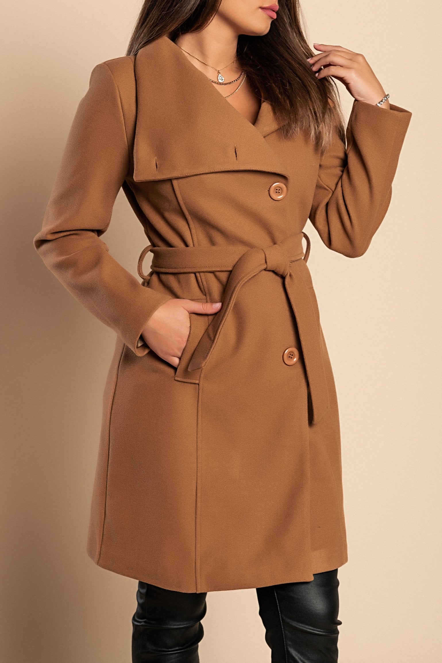 Elegant camel coat with buttons, featuring a high collar, decorative belt, and side pockets.