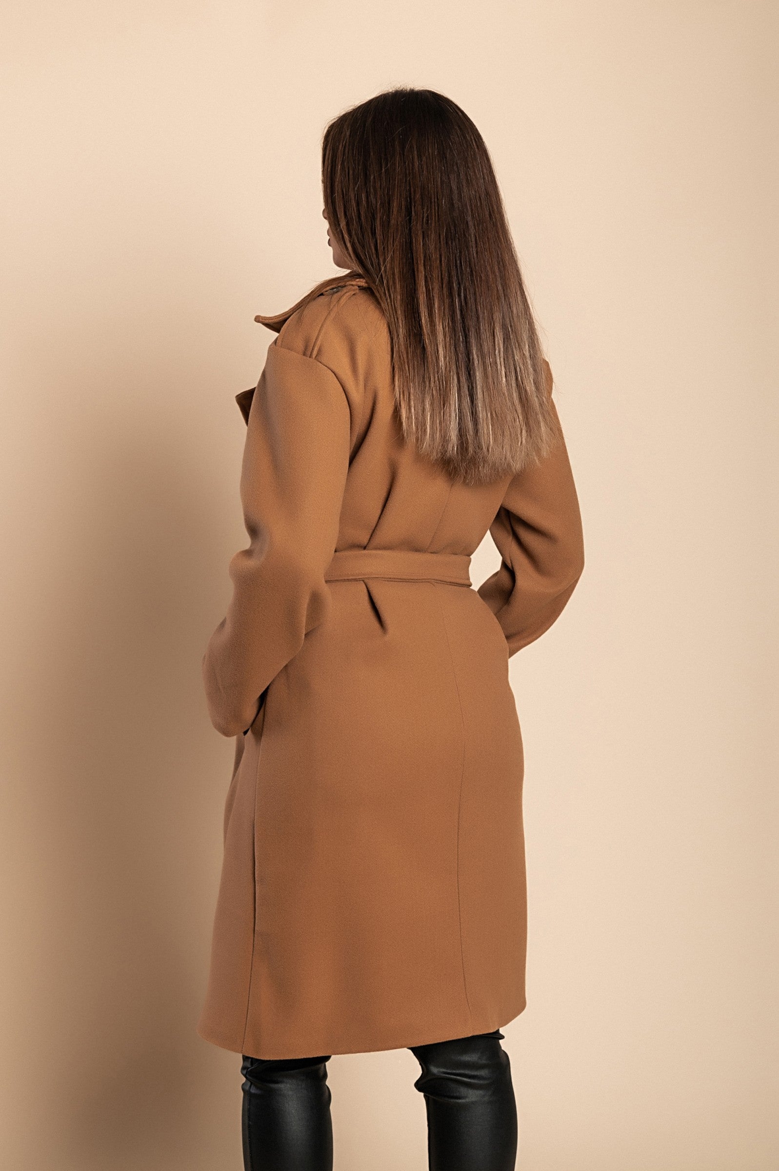 Elegant camel coat with buttons, featuring a classic collar and decorative belt, knee-length design with side pockets.