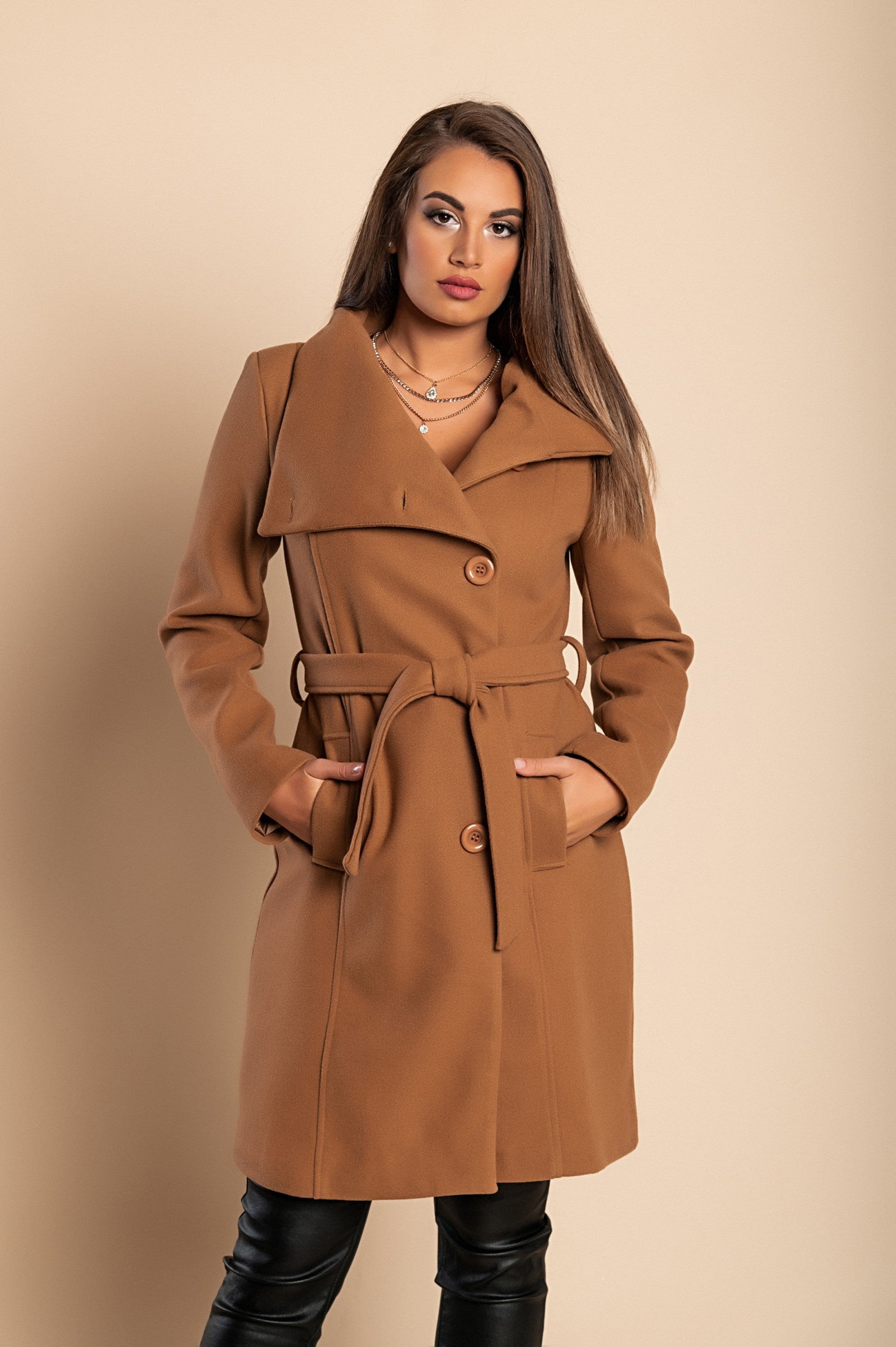 Elegant camel coat with buttons, featuring a high collar, long sleeves, and decorative belt, perfect for stylish layering.