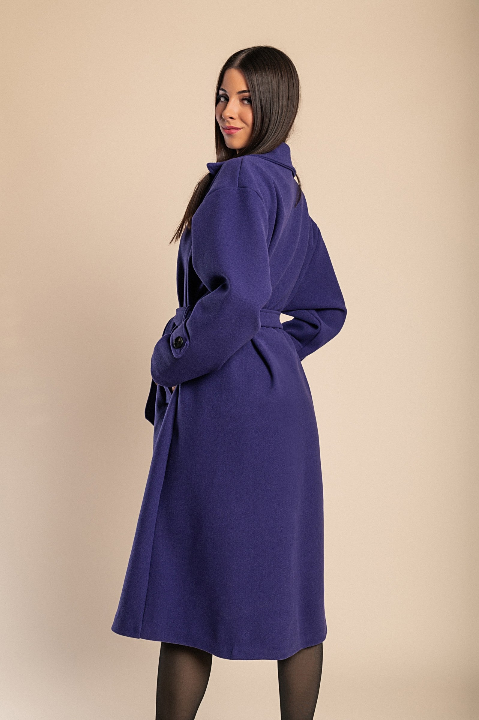 Elegant purple coat with buttons, featuring a classic collar, long sleeves, and a decorative belt, perfect for winter fashion.