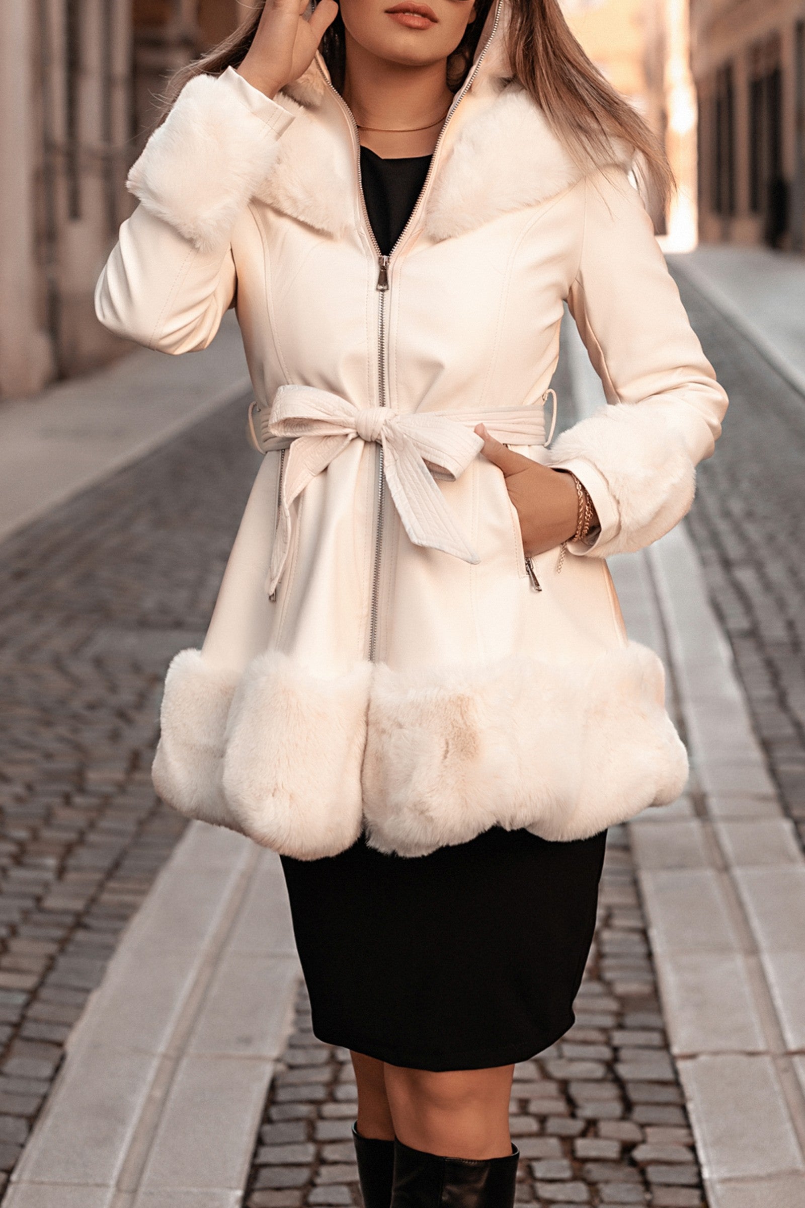 Elegant white coat with faux fur hood and details, featuring a full zip closure and front pockets.