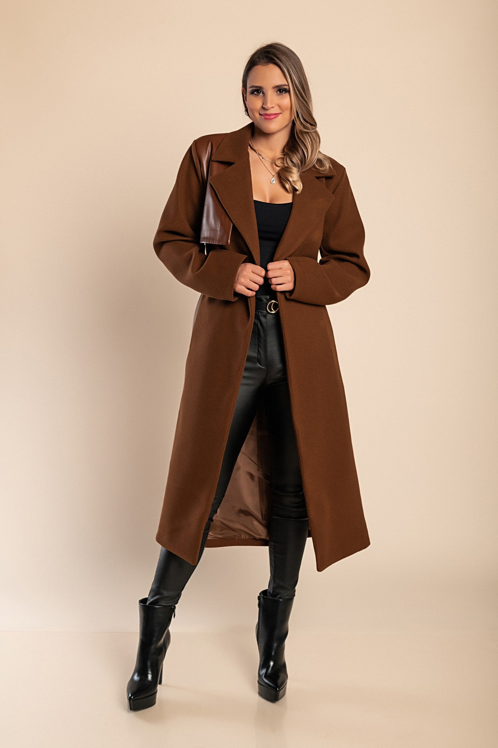 Elegant brown coat featuring faux leather details, classic collar, button closure, and decorative belt, perfect for stylish warmth.