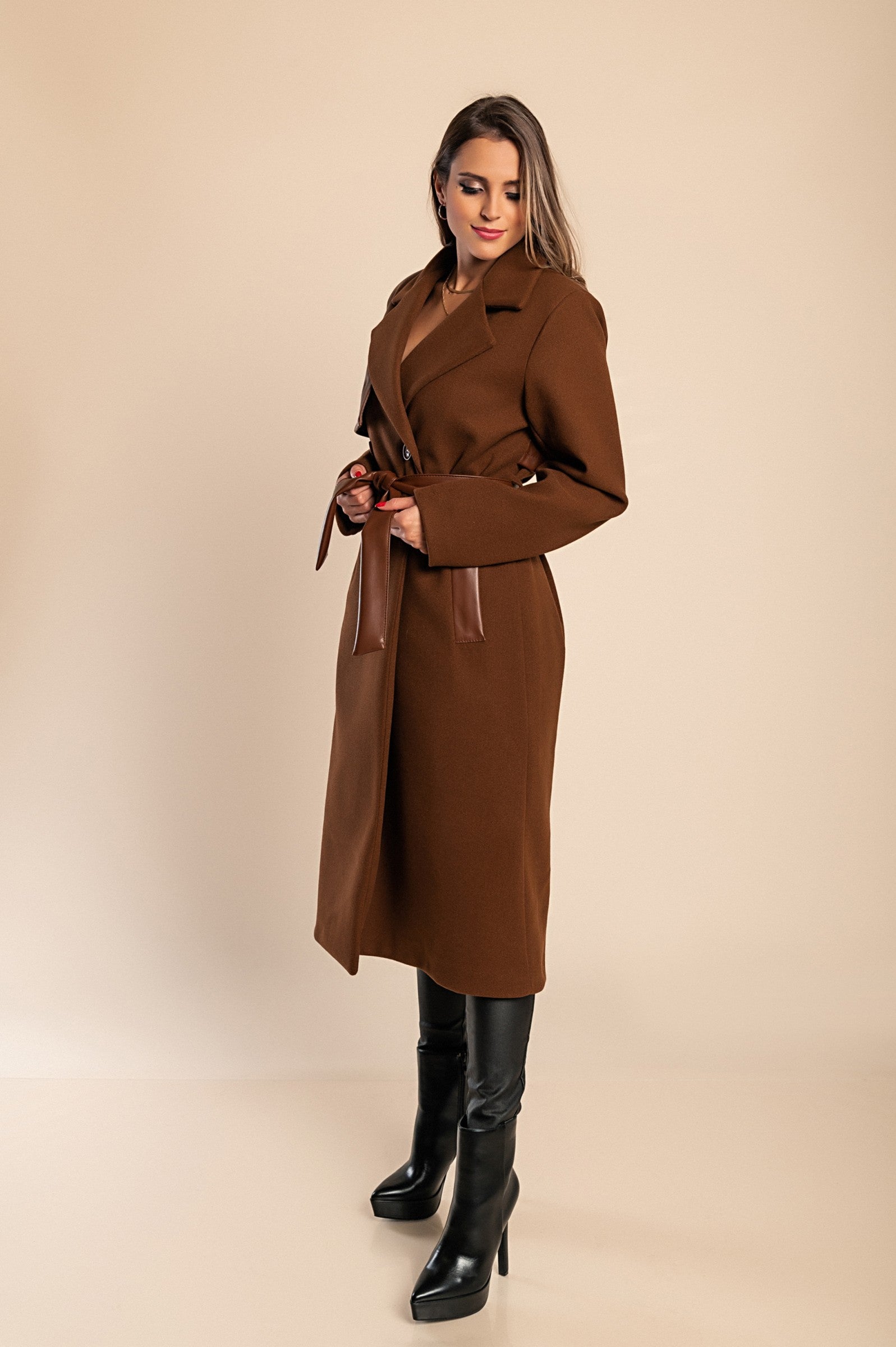 Elegant brown coat featuring faux leather details, classic collar, button closure, and decorative belt, perfect for stylish warmth.