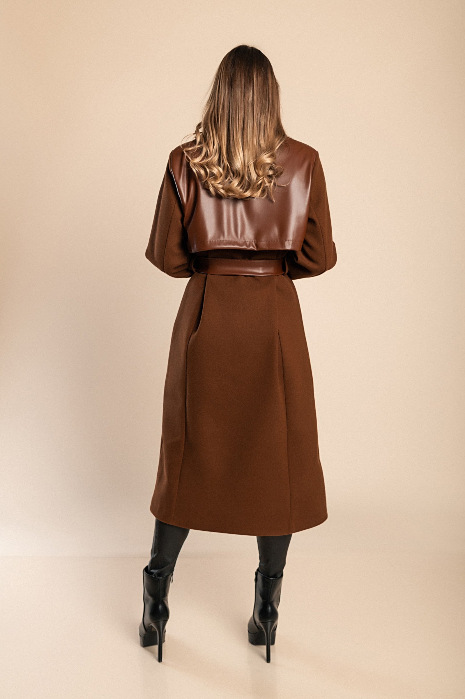 Elegant brown coat featuring faux leather details, classic collar, button closure, and decorative belt, perfect for stylish warmth.