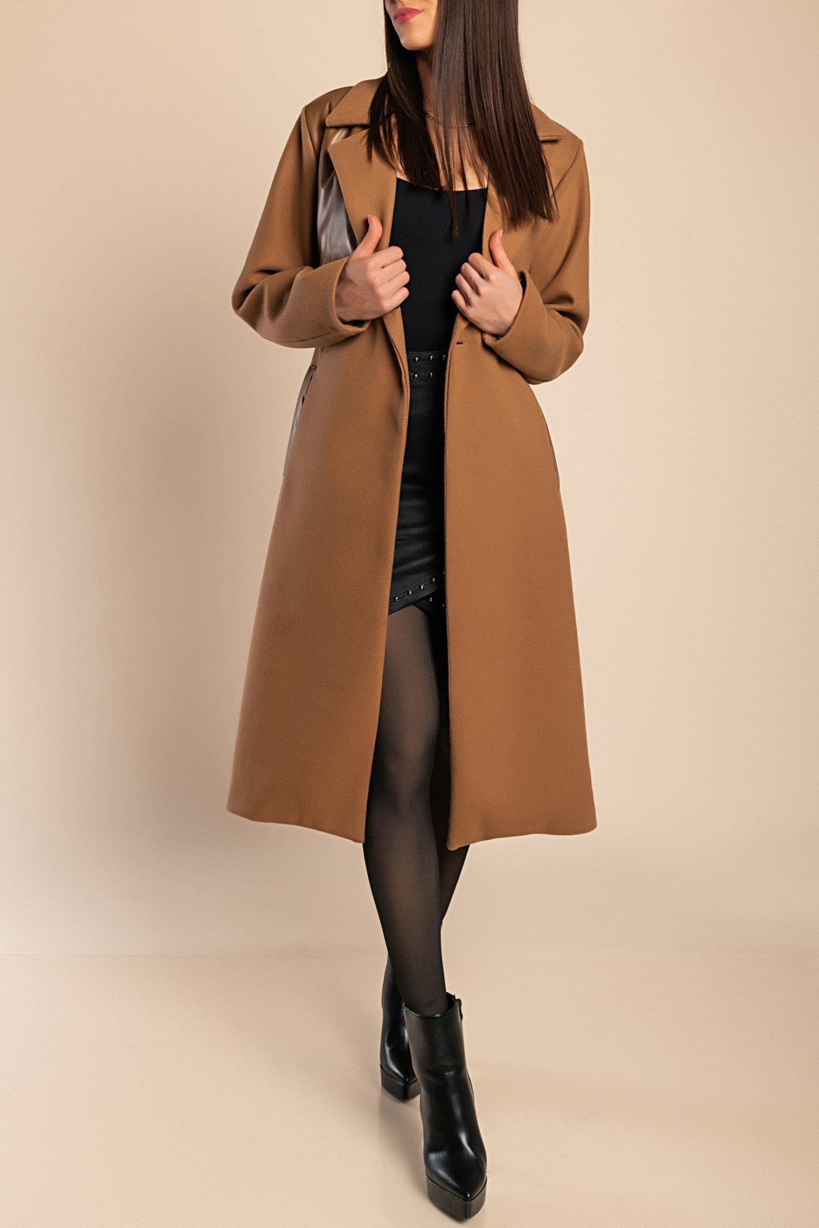 Elegant camel coat featuring faux leather details, classic collar, button closure, and decorative belt, perfect for stylish warmth.