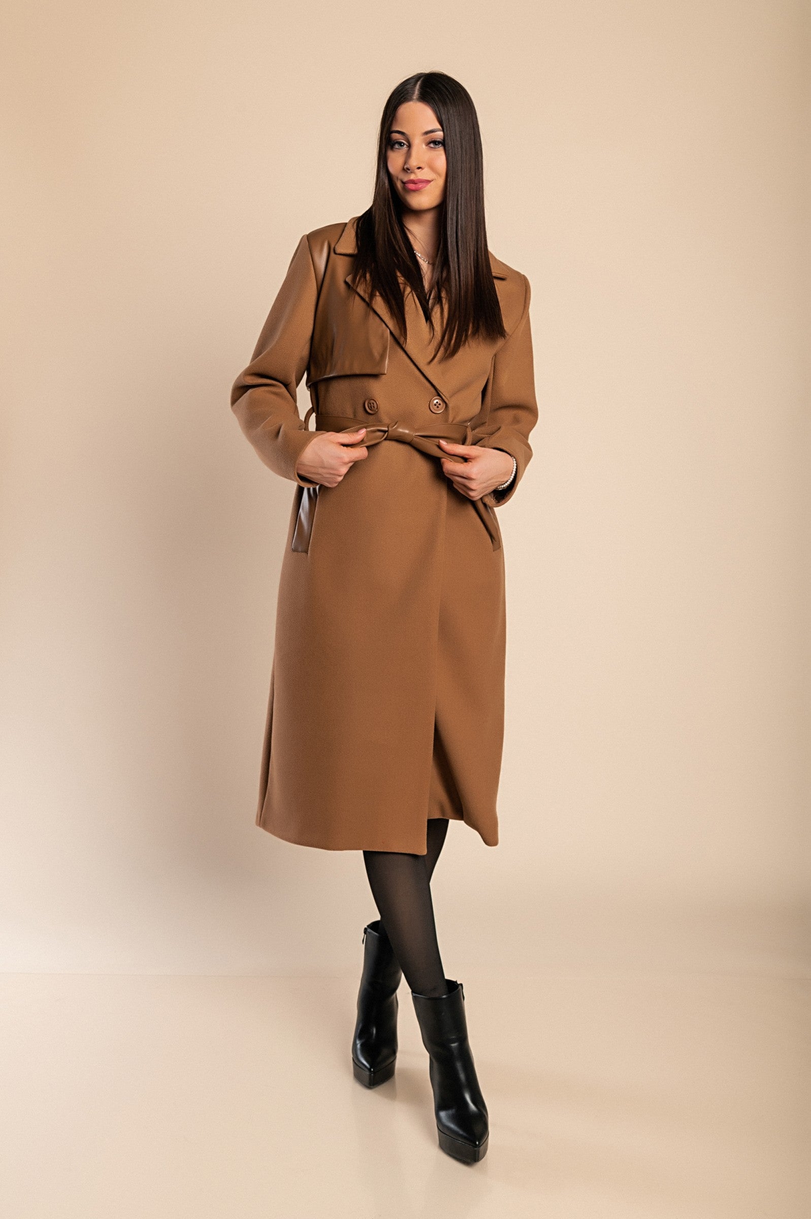 Elegant camel coat featuring faux leather details, classic collar, button closure, and decorative belt, perfect for stylish warmth.