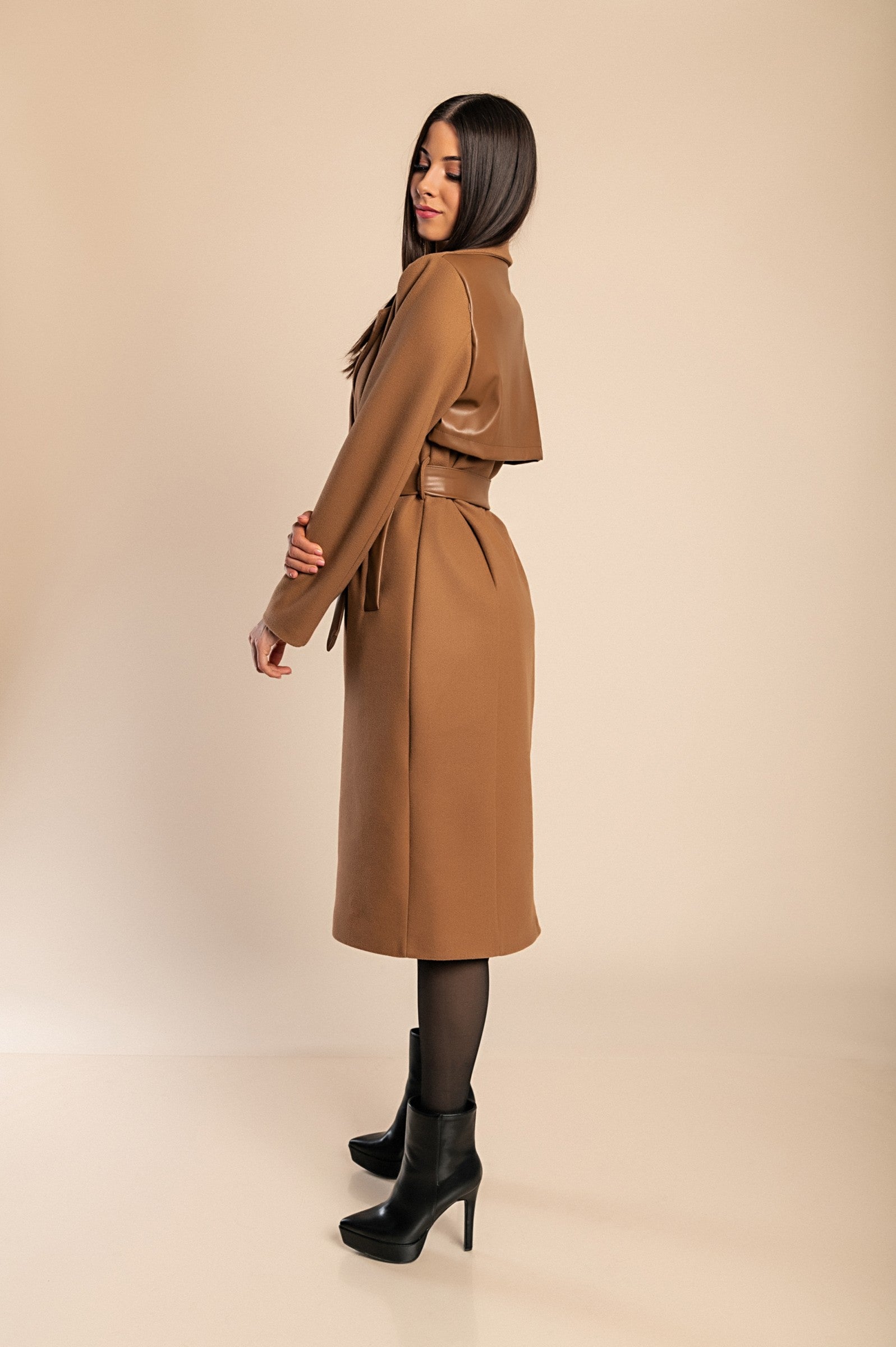 Elegant camel coat featuring faux leather details, classic collar, button closure, and decorative belt, perfect for stylish warmth.