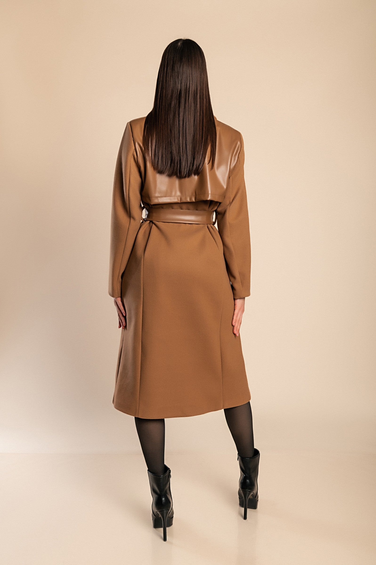 Elegant camel coat featuring faux leather details, classic collar, button closure, and decorative belt, perfect for stylish warmth.