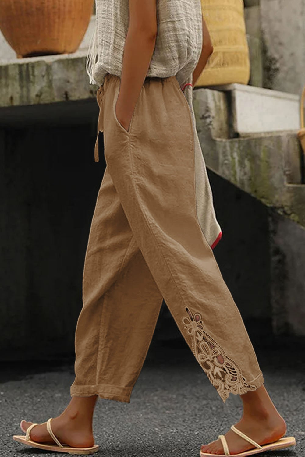 Elegant khaki cotton trousers with lace detailing, featuring an elastic and drawstring waist.