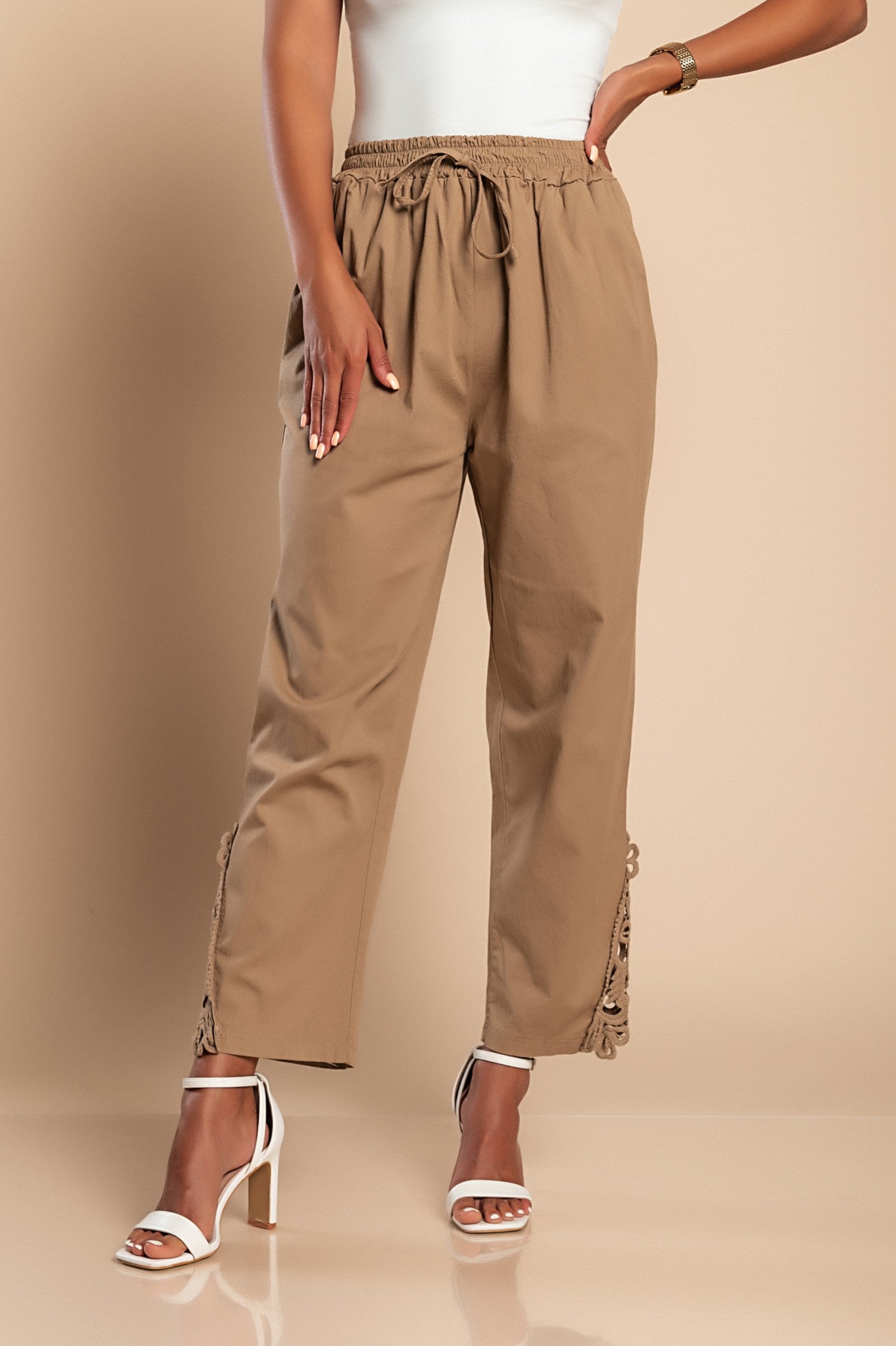 Elegant khaki cotton trousers with lace detailing, featuring an elastic and drawstring waist.