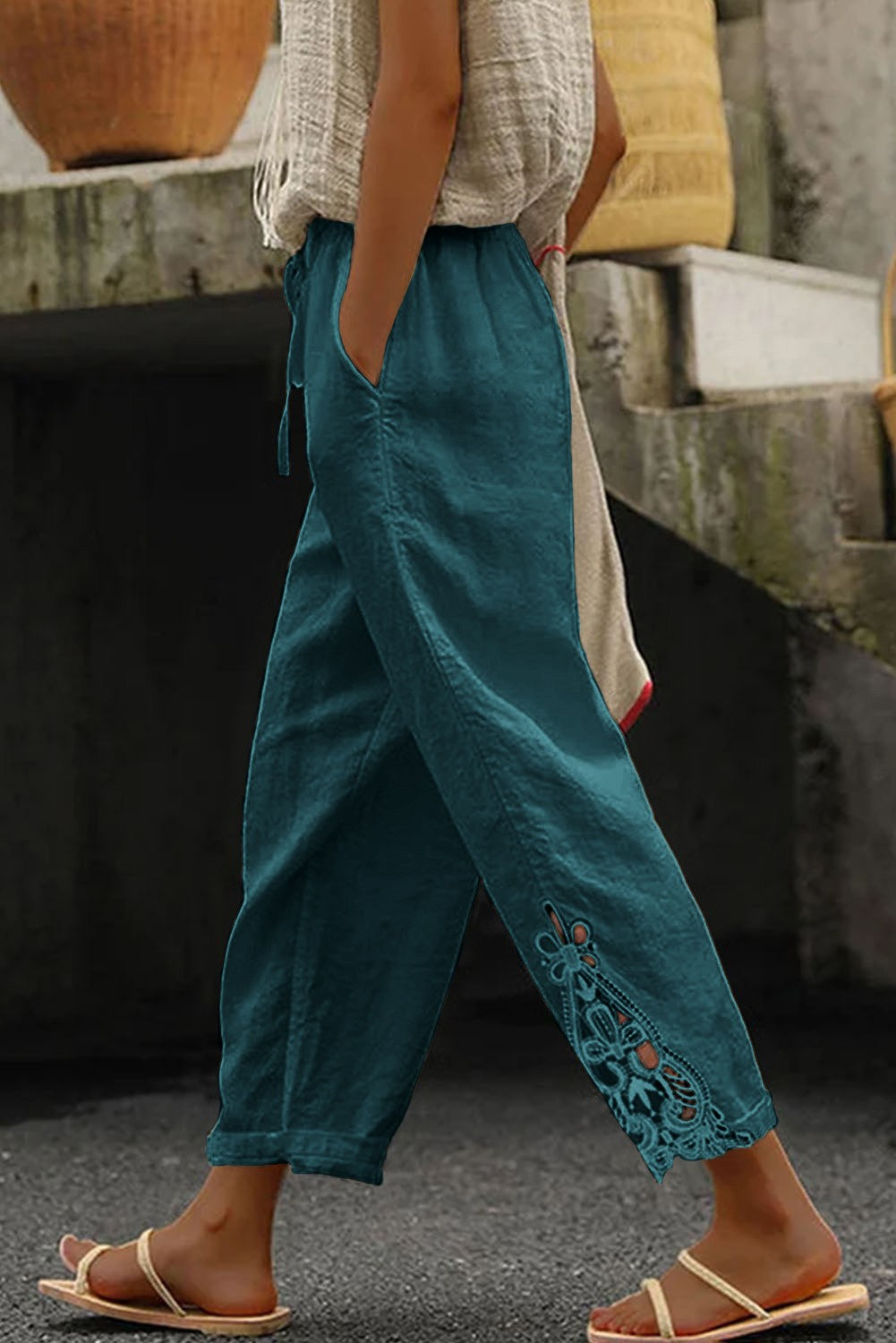 Elegant petrol cotton trousers featuring lace detailing and a drawstring waist, perfect for stylish comfort.