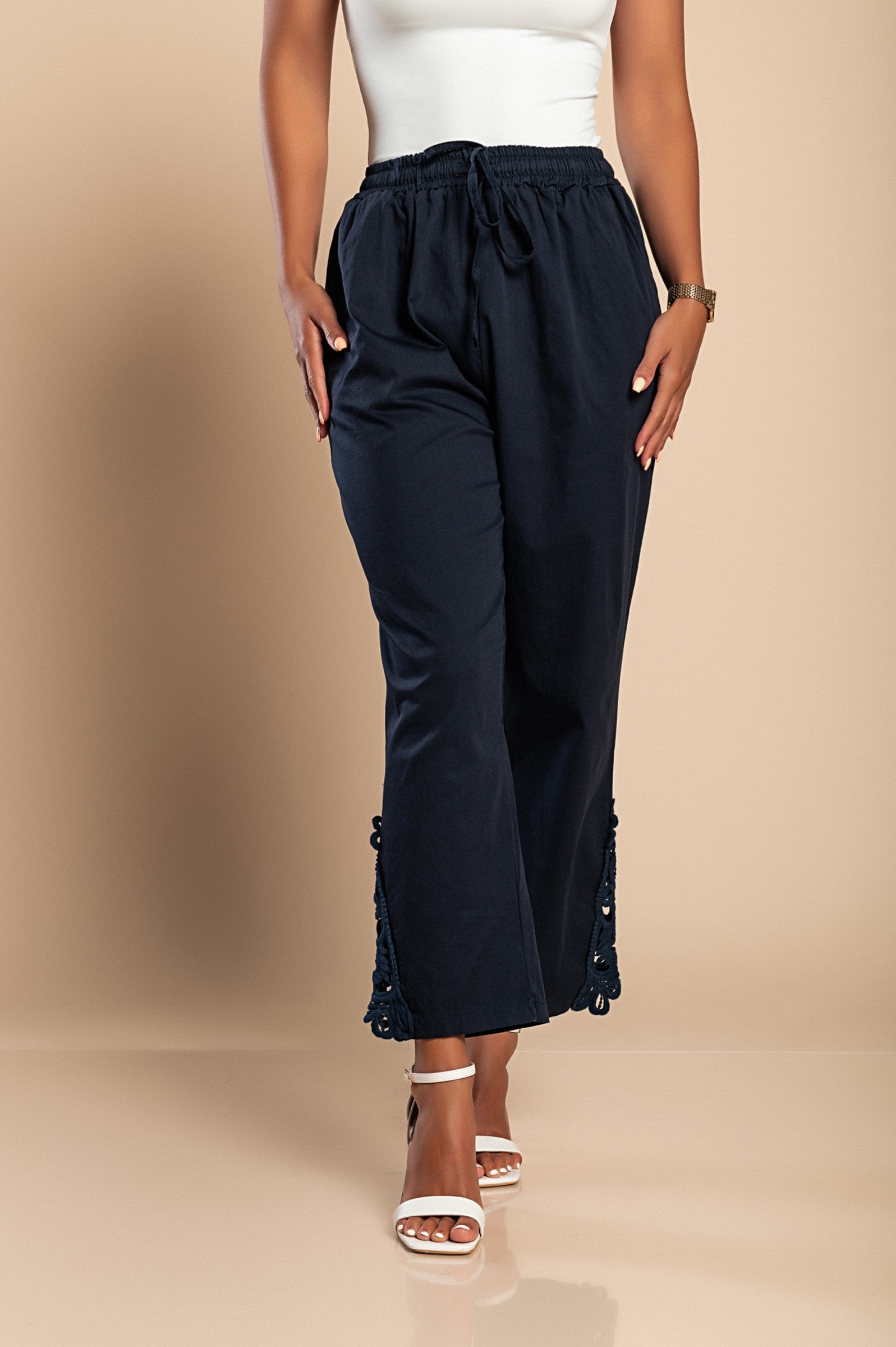 Elegant dark blue cotton trousers with lace trim, featuring an elastic and drawstring waist, designed for comfort and style.